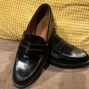 Women's black penny loafers by Amore.